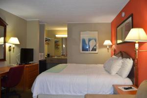 a hotel room with a bed and a desk at New Travel Inn in Kingsport