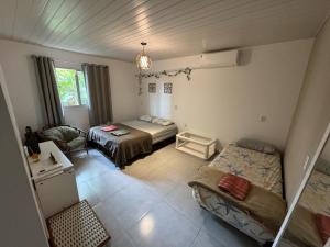 En eller flere senge i et værelse på Breeze Floripa - Campeche