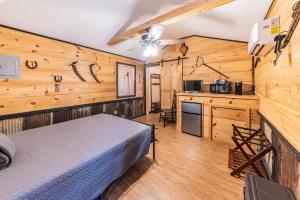 une chambre avec un lit dans une pièce aux murs en bois dans l'établissement The Outpost, à Grand Rivers