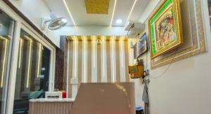 a room with a bench and a painting on the wall at Madhu Stay in Chhatikara
