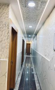 an empty corridor with a long hallway at Madhu Stay in Chhatikara