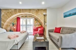 a living room with a bed and a couch at Studio Alienor Place la Bourse Bordeaux in Bordeaux