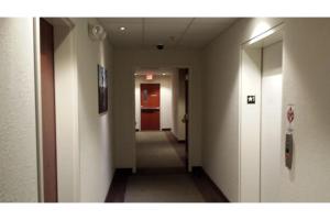 a hallway with a long corridor with a hallway at Pleasant Night Inn Carthage Near Fort Drum in West Carthage