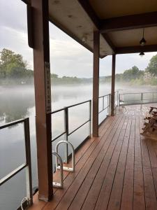 a wooden deck with a view of the water at Branson Lakeside Getaway in Branson