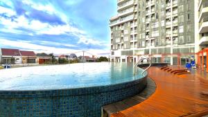 a large swimming pool in front of a building at Escotel Amazana in Cileduk 1