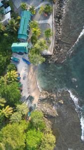an overhead view of a beach with chairs and the water at Casa Mamré in Cahuita