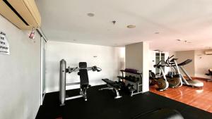 a gym with several exercise equipment in a room at Escotel Amazana in Cileduk 1