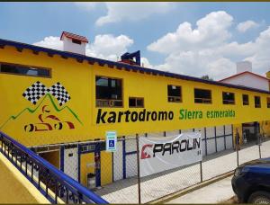 een geel gebouw met een bord aan de zijkant bij House in the Forest 