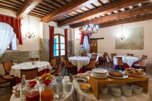 a restaurant with tables and chairs with food on them at Villa Rinalducci in Fano