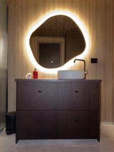 a bathroom with a sink and a mirror on a dresser at Exclusive Cabin with Sauna in Fossmo +20 photos