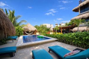 a resort with a swimming pool and chairs and a resort at Island Escape for Groups Hosted by Atenea Holbox in Holbox Island