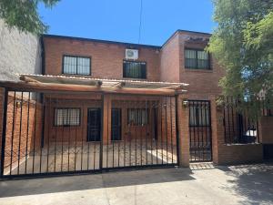 an iron gate in front of a brick building at Cava del Sur in San Rafael