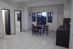 a kitchen and dining room with a table and chairs at Condo Unit 5A in Batangas City in Batangas City