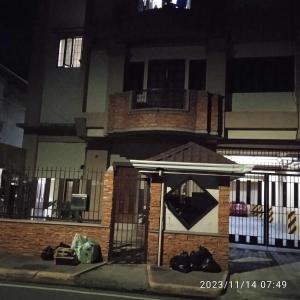 a building with a front door with a fence at Condo Unit 5A in Batangas City in Batangas City +9 photos