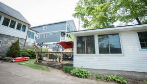 a house with a deck with an umbrella on it at Cottage on Crystal Beach 3BR & BBQ in Fort Erie +12 photos