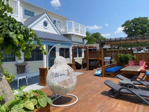 a patio with a large glass vase on a wooden deck at Water Front Beach House - 3BR w BBQ & Sunset in Fort Erie