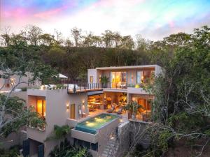 an aerial view of a house with a swimming pool at 3086 - TreeTop Villa in Tangolunda