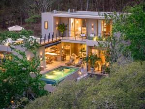 an aerial view of a house with a swimming pool at 3086 - TreeTop Villa in Tangolunda