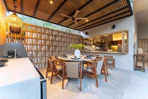 an outdoor dining room with a table and chairs at 3086 - TreeTop Villa in Tangolunda