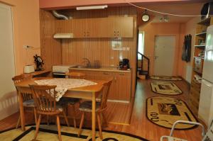a kitchen with a table and chairs in a room at Cabana Ovidiu in Râu de Mori