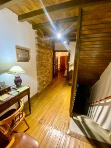 an attic room with a wooden floor and a staircase at Casa Pueblo Anibal in Fermoselle