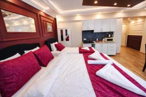 a large bed with red and white pillows in a room at Valentina Apart Hotel in Istanbul