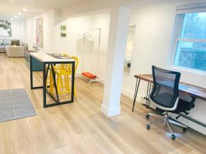 an office with a desk and a chair and a table at Fresh Modern Garden Level Kittery Studio in Kittery +11 photos