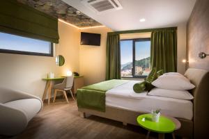 Ein Bett oder Betten in einem Zimmer der Unterkunft Hotel Vinotel Gospoja