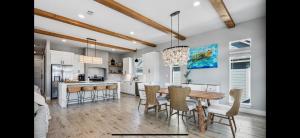 a kitchen and dining room with a table and chairs at Perfect Beach Getaway Home! in Crystal Beach +8 photos