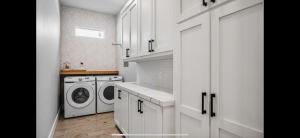 a white laundry room with a washer and dryer at Perfect Beach Getaway Home! in Crystal Beach