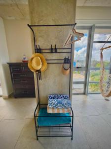 a room with a chair with a hat on it at Spacious Loft-Sea view Atlantis by Stay Here PR in San Juan