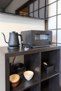 a microwave and a toaster oven on a shelf at Kulton Moct Kenroku in Kanazawa
