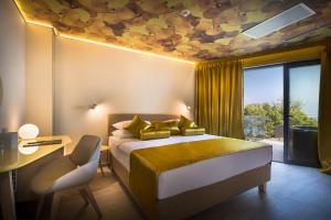 a bedroom with a bed with a yellow ceiling at Hotel Vinotel Gospoja in Vrbnik +37 photos