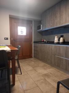 a kitchen with a table and a window in it at Da Milena in Frabosa Sottana