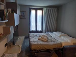 a bedroom with a bed with two towels on it at Da Milena in Frabosa Sottana