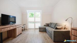 un soggiorno con divano e TV a schermo piatto di Hostel Migrand a Stettino