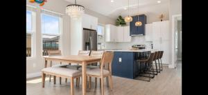 a kitchen with a wooden table and chairs in a kitchen at Stunning Beach Front House in Crystal Beach