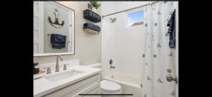 a bathroom with a sink toilet and a shower at Stunning Beach Front House in Crystal Beach +6 photos