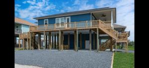 a large house with a deck on the side of it at Stunning Beach Front House in Crystal Beach