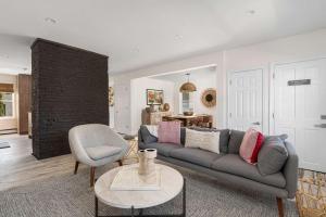 a living room with a couch and a chair at The Return to Self - Walk to Historic Downtown in Warren