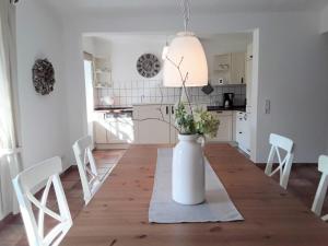 a kitchen and dining room with a table with a vase with flowers at Apartment Marie-Luise by Interhome in Ferchesar