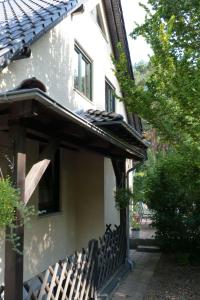 a house with a fence next to a building at Apartment Am Marsfeld by Interhome in Borkheide