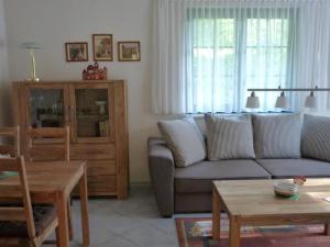 a living room with a couch and a table at Apartment Am Marsfeld by Interhome in Borkheide