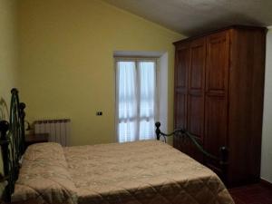 a bedroom with a bed and a dresser and a window at La Macina di Bettona in Bettona