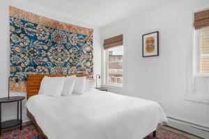 a bedroom with a large white bed and a tapestry at The Return to Woods - Newly Designed & Renovated in Warren