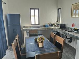 a kitchen with a table and chairs and a kitchen counter at La Conchita de Sisal 7 in Sisal