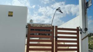 a wooden fence with a flag on top of a building at La Conchita de Sisal 7 in Sisal