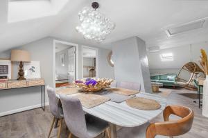 a dining room with a white table and chairs at The Return - Multi-Unit Retreat - Sleeps 16 - Spa in Warren