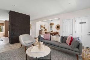 a living room with a couch and a chair at The Return - Multi-Unit Retreat - Sleeps 16 - Spa in Warren +123 photos