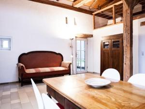 a living room with a table and a couch at Apartment Studio by Interhome in Schernfeld